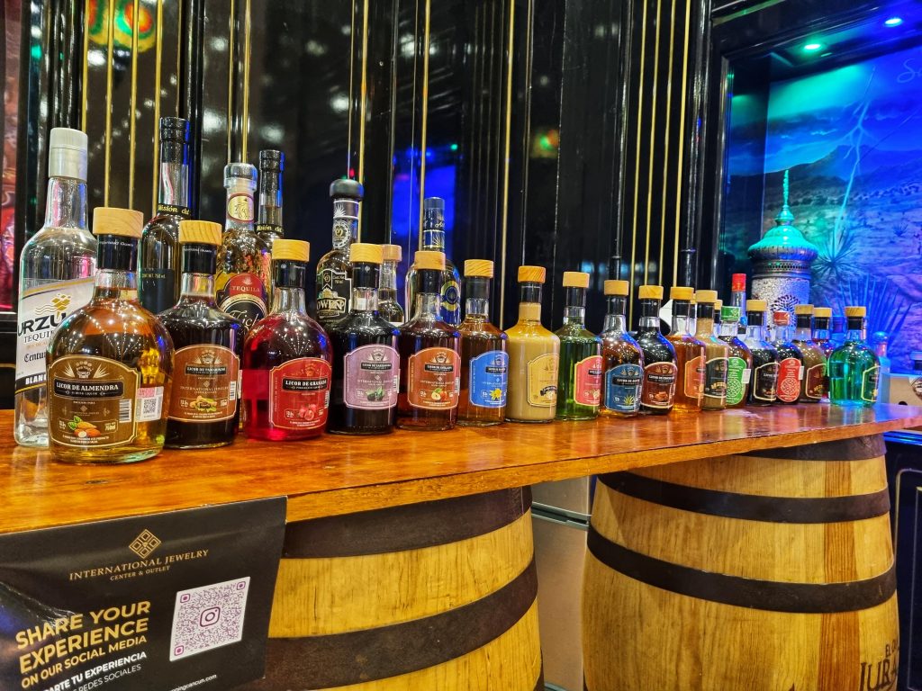 Downtown Cancun tour showing bottles of the different tequila and liquer in the international jewelery store.