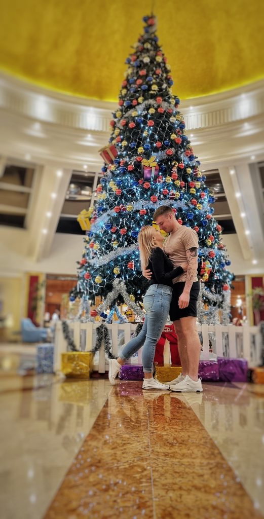 Amy & Liam in front of the Christmas tree at Labranda Royal Makadi Hotel.