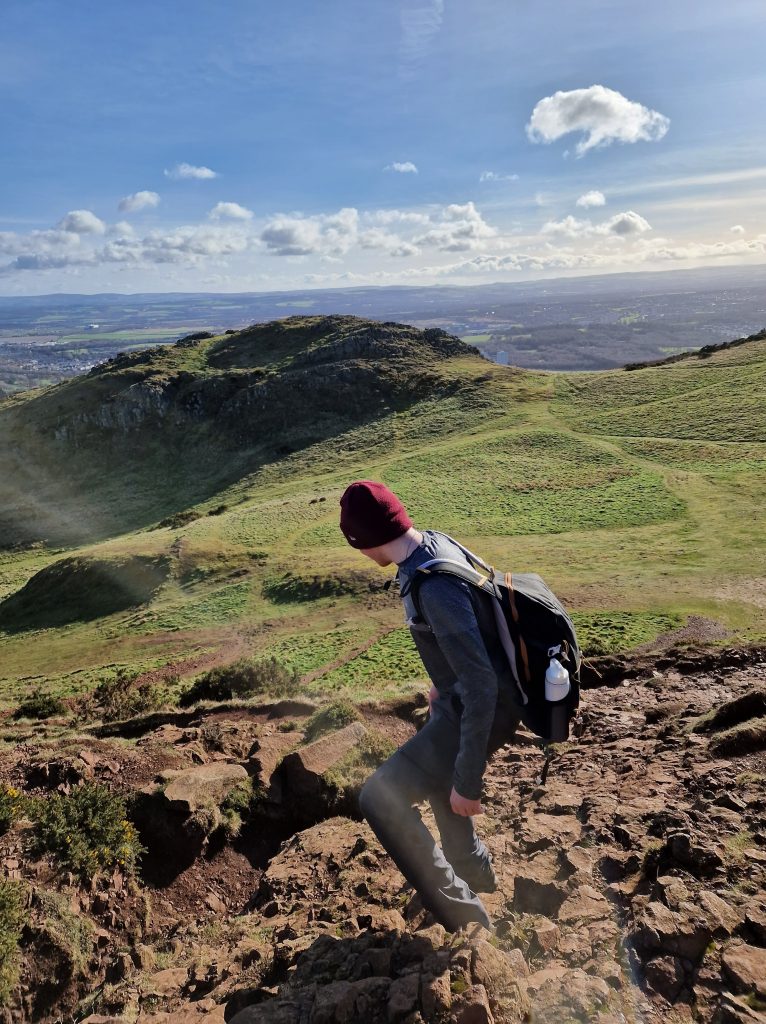 Liam walking down Arthur's Seat, as t is quite steep it can be tricky to walk down.