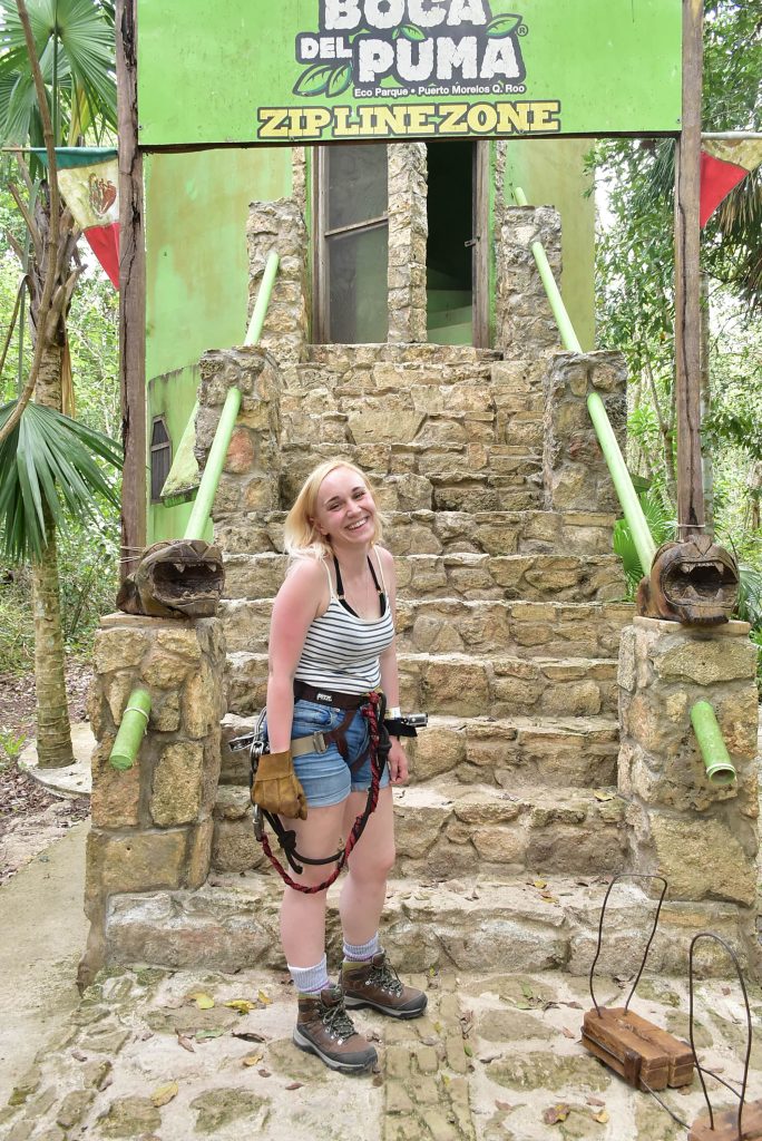 Amy standing in front of the Boca del Puma ziplining zone in Cancun.