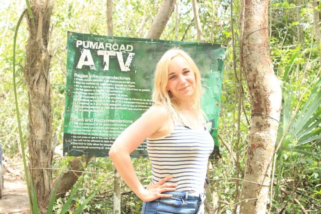 Amy having her photo taken in front of the Puma Road ATV sign.