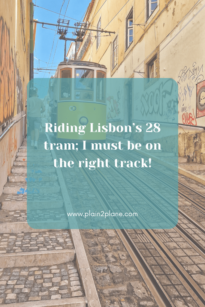 The yellow tram in Lisbon with the caption "Riding Lisbon’s 28 tram; I must be on the right track!"