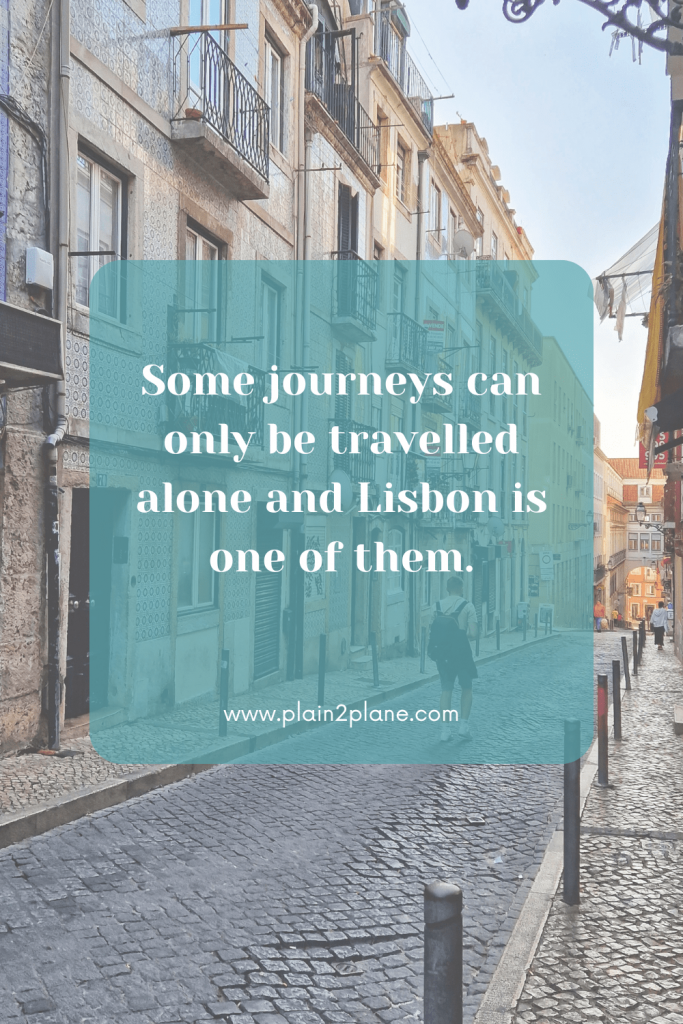 Streets of Lisbon with the caption "Some journeys can only be travelled alone and Lisbon is one of them."