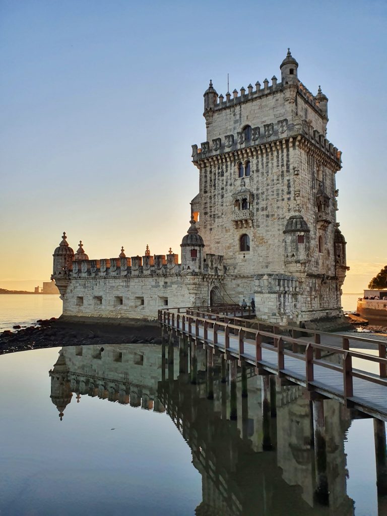 Belem Tower with the sun setting in the background.