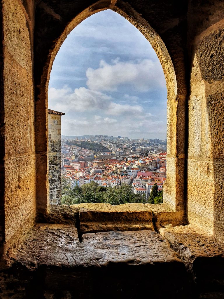 Beautiful viewpoint from Castelo de Sao Jorge which you can see through an arch window.