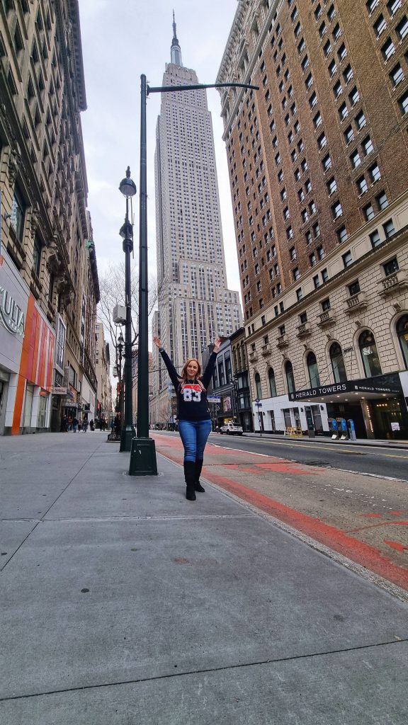 Amy standing below the Empire State Building.