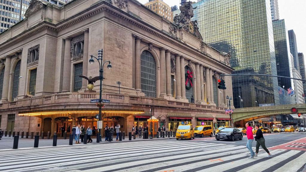 Outside Grand Central Station with yellow taxi cabs going pass.