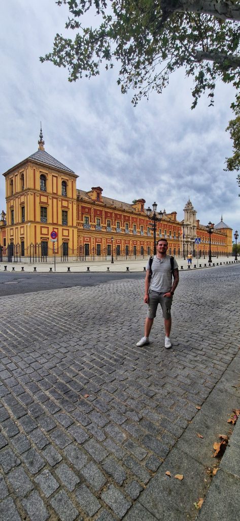 Liam standing in front of one of the many beautiful buildings in Seville. The architecture is yellow and red so it stands out very easily!
