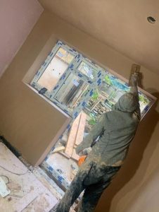 applying plaster to a wall