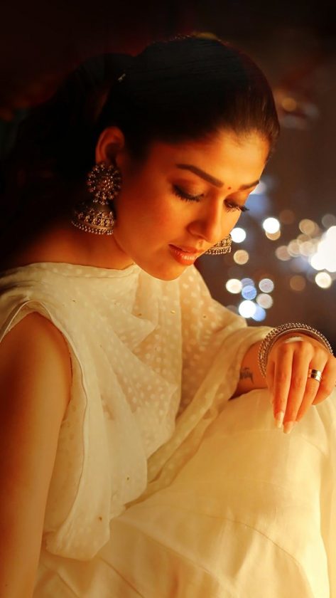 Nayanthara sitting on floor in a temple