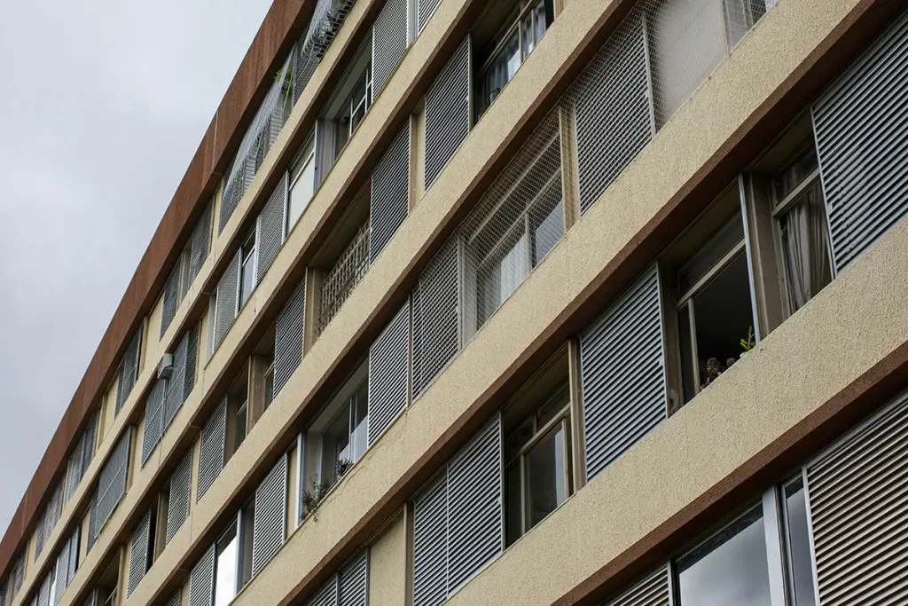 Nowoczesny blok mieszkalny z metalowymi żaluzjami na fasadzie, Dania.