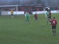 Joel Leversedge winning a header at Llansantffraid