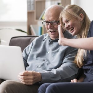 smiley-old-man-nurse-having-video-call-laptop