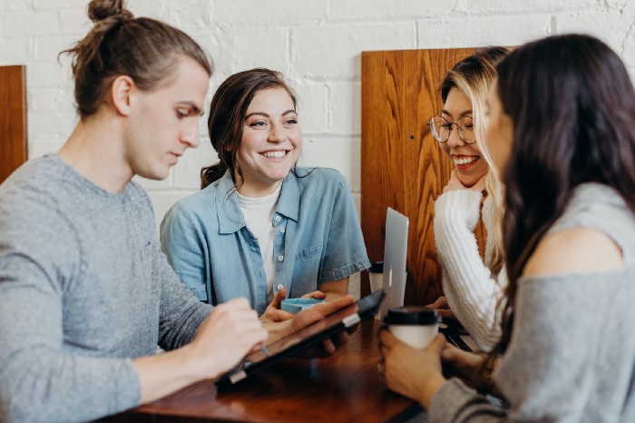 Four people engaged in communication and work.