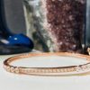 Sterling Silver Rose Gold Bangle .925 sterling silver solid bangle with a 18k rose gold plating and decorated with cubic zirconia stone to create this delicate looking bracelet. Lever fastening with 2 arm safety clasps.