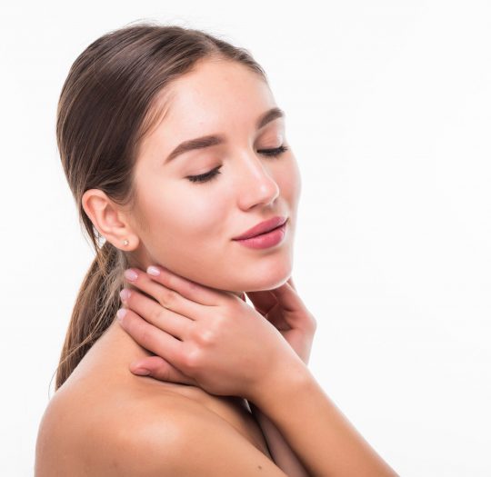 Beautiful sensual woman touching her face. Beauty and skincare concept. Spa. Isolated over white.