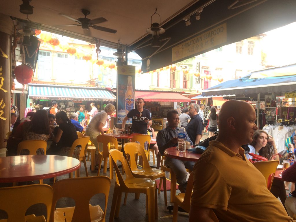 a picture of tourists sitting at a cafe in China Town