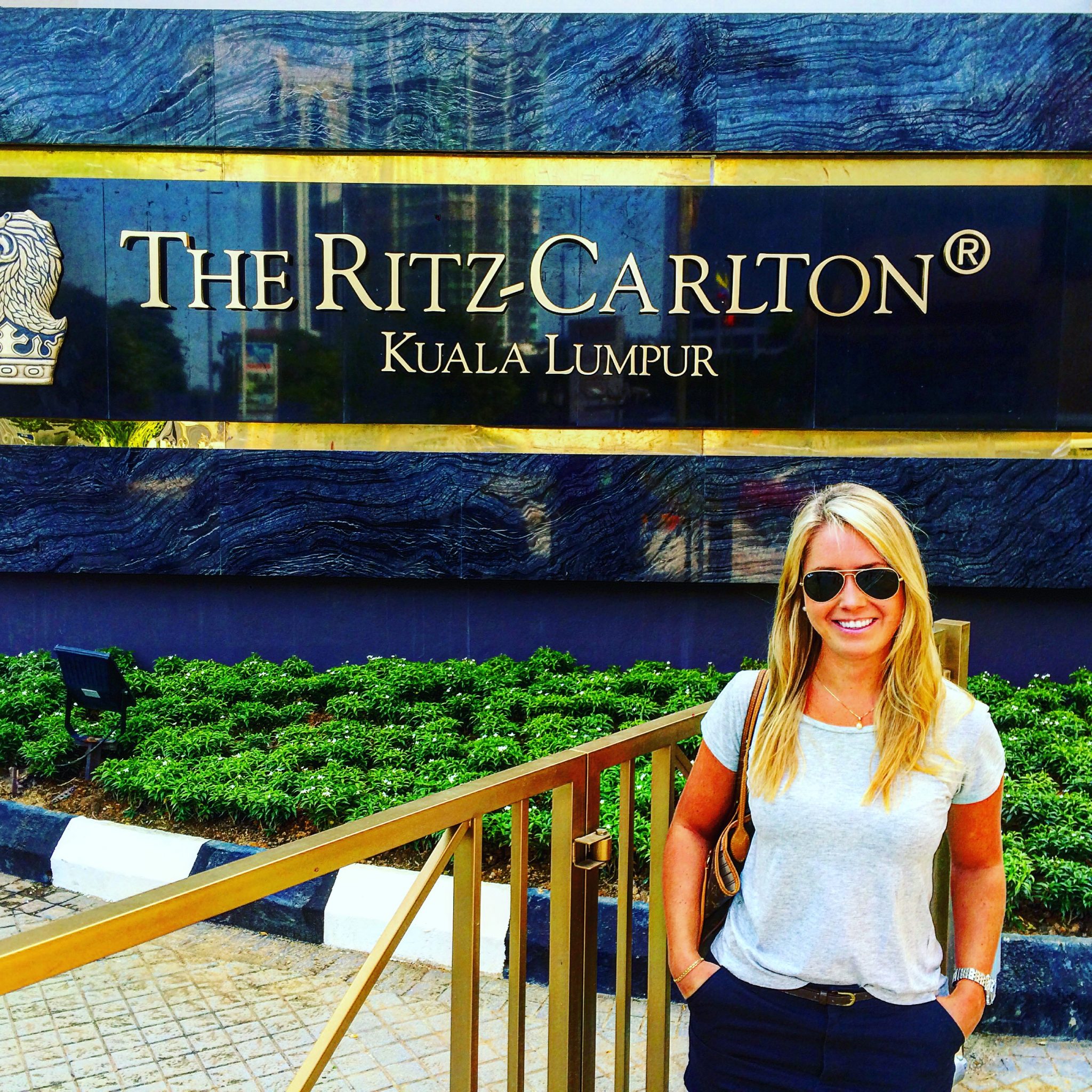 A picture of me standing outside the Ritz Carlton hotel in Kuala Lumpur