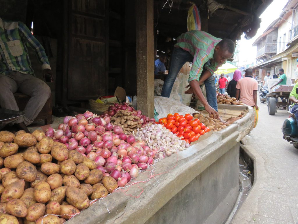 vegetable seller arranging his stall