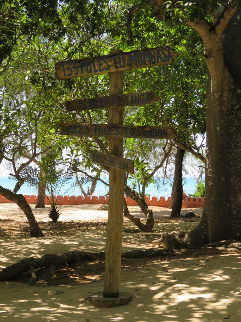 a picture of a sign giving distances to different places