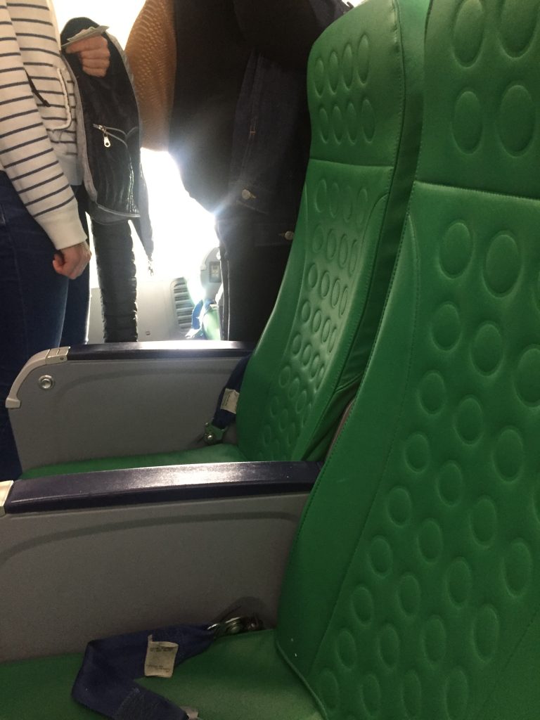 a picture of designer green seats on the airplane