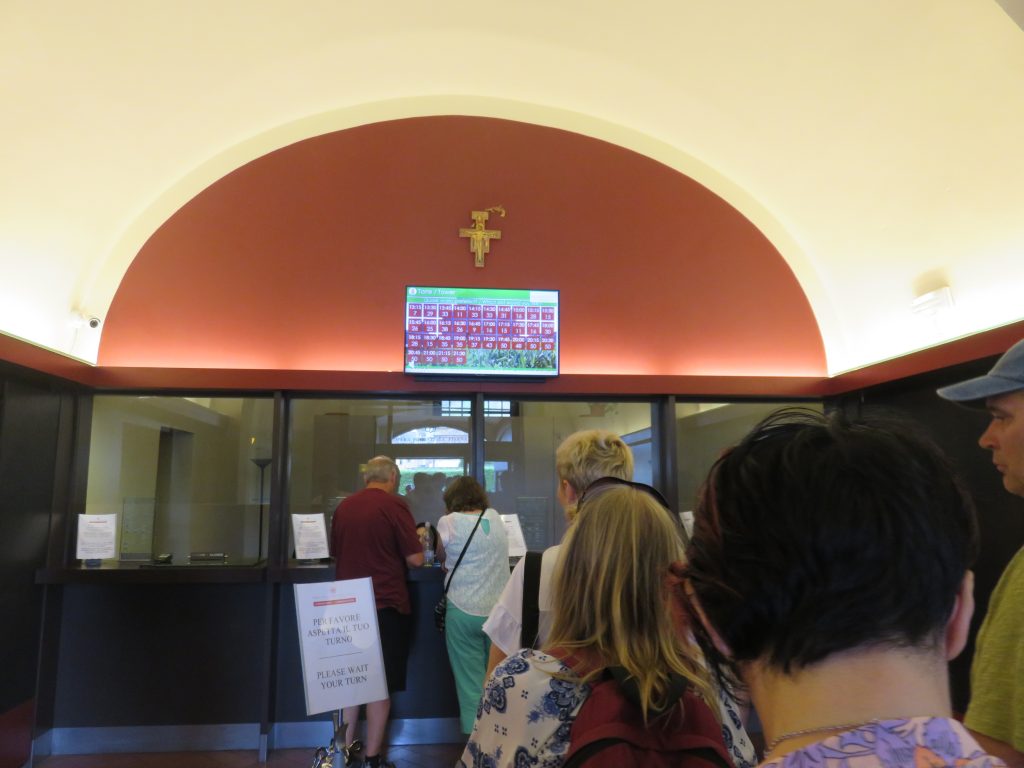 a picture of tourists buying tickets 