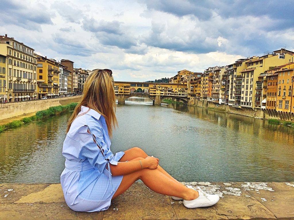 A picture of me sitting on a bridge looking at Ponte Veccio