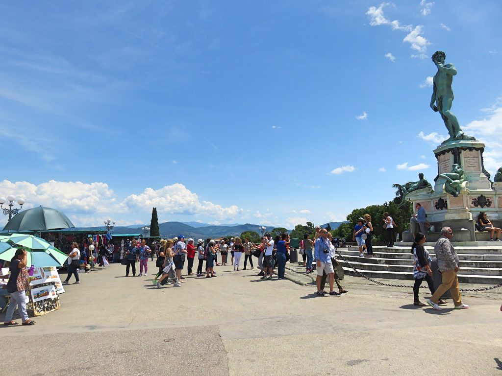 A picture of tourists taking pictures of the sculpture of David