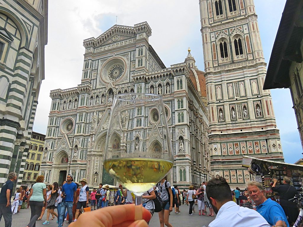 A picture of me holding a glass of wine outside Cattedrale di S.Maria del Fiore