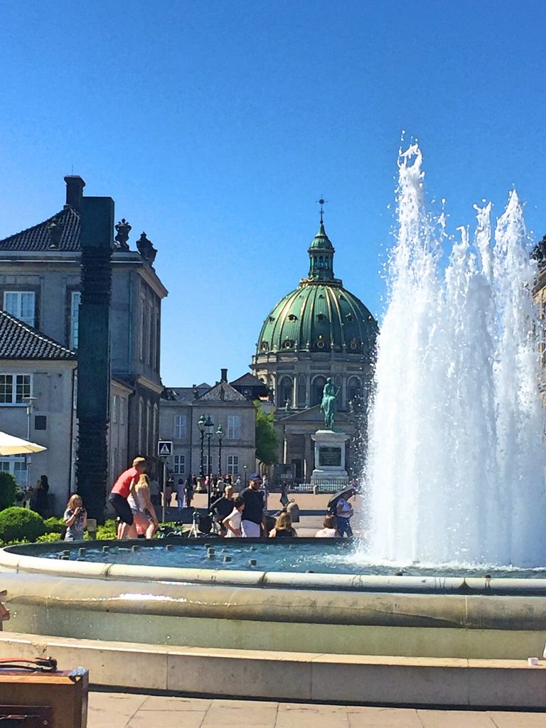 A picture of tourists at the fountain opposite the Copenhagen castle