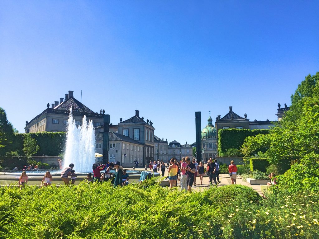 A picture of tourists taking photos beside the fountain