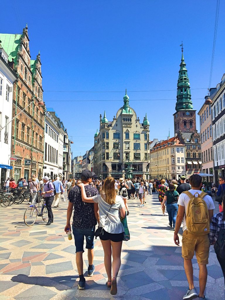 A couple holding each other and walking on the street