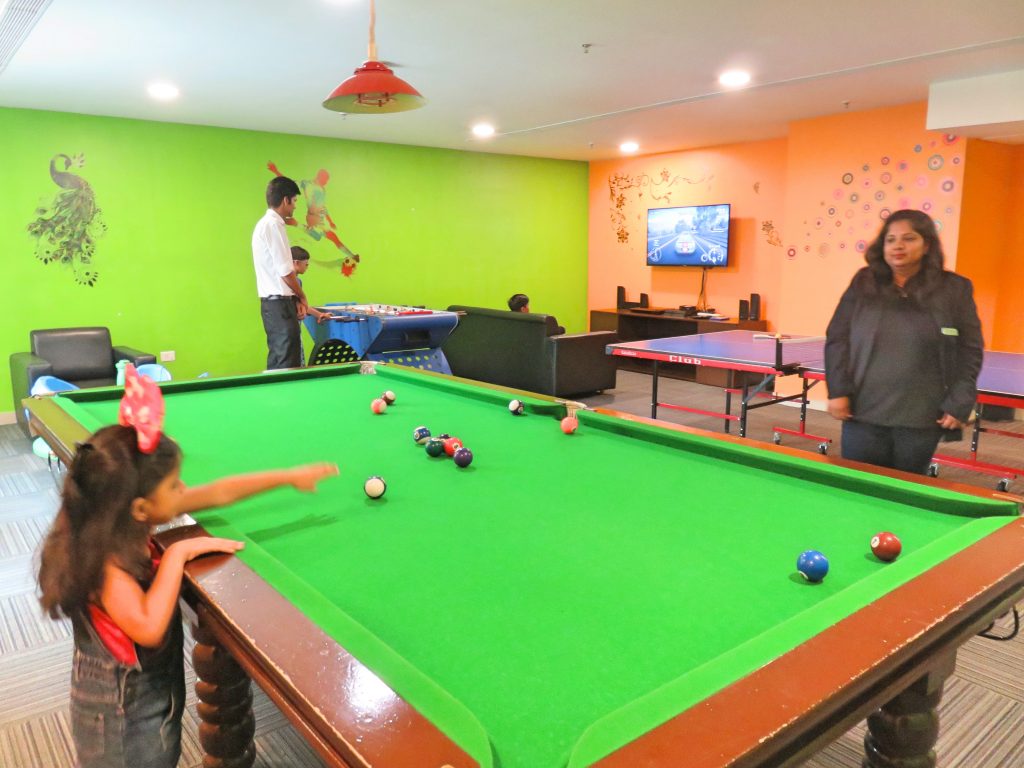 A picture of games room with a pool table video games and table tennis