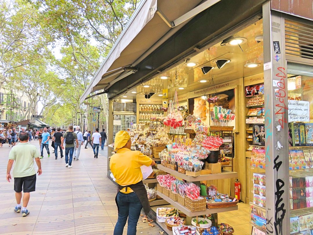 Lady arranging candy at her store at La Rambla Barcelona