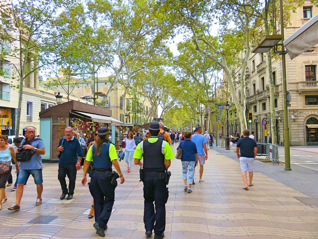 Two policeman walking on duty at La Rambla Barcelona