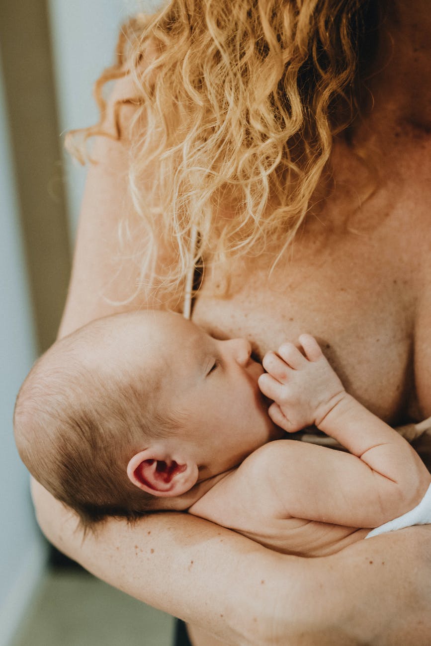 woman breastfeeding child