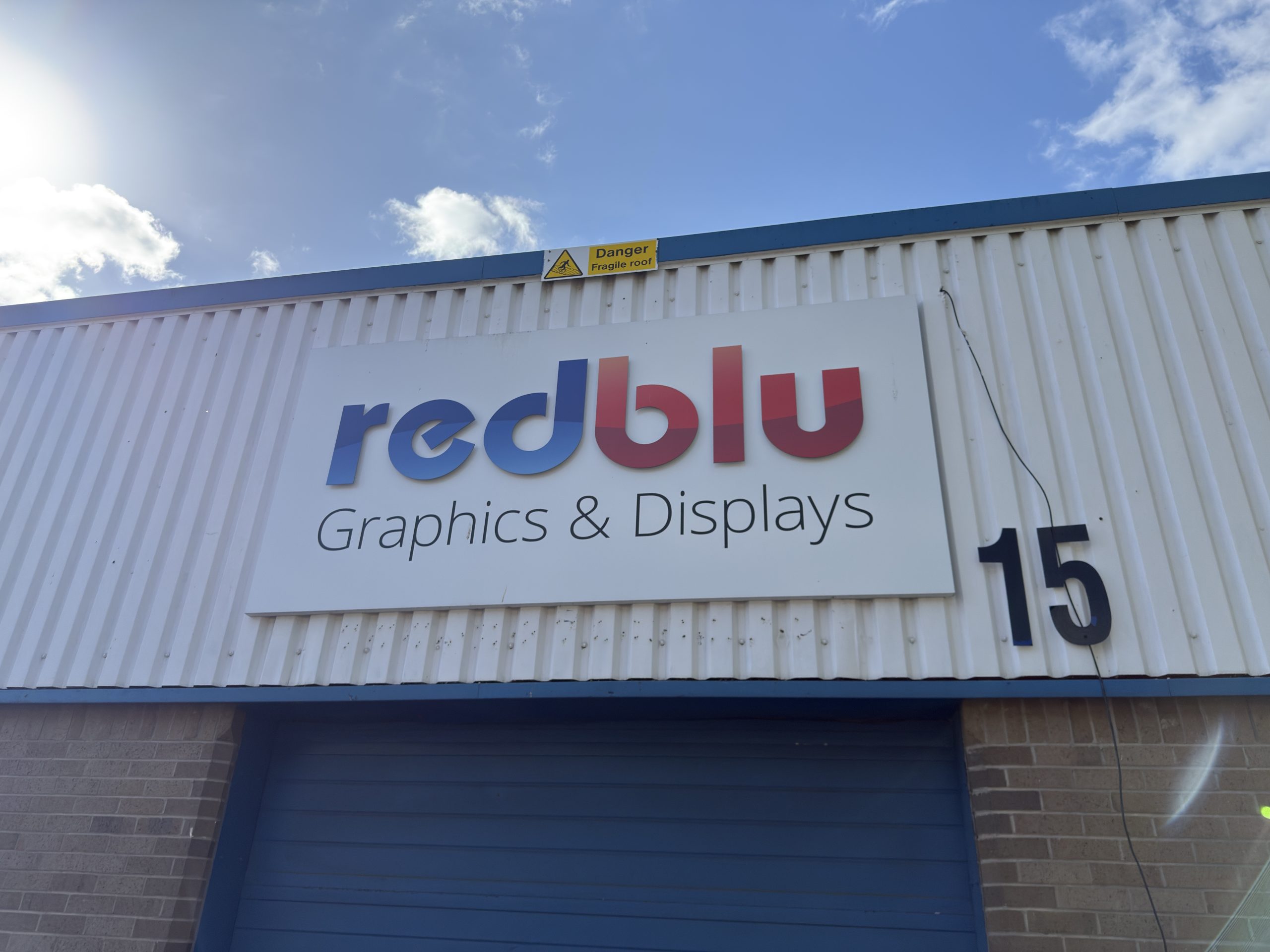 Redblu HQ Modular Exhibition Stand Builder Redblu HQ sign outside.