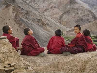 youngpriest boys sitting on the ground looking around