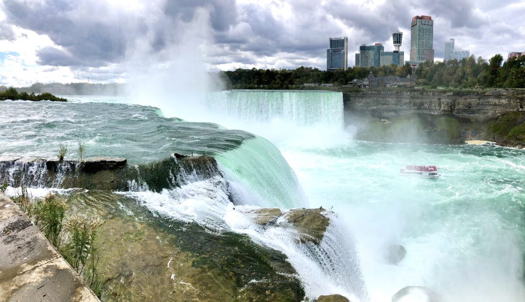 Cascading waterfalls and Maid of the Mist at Niagara Falls