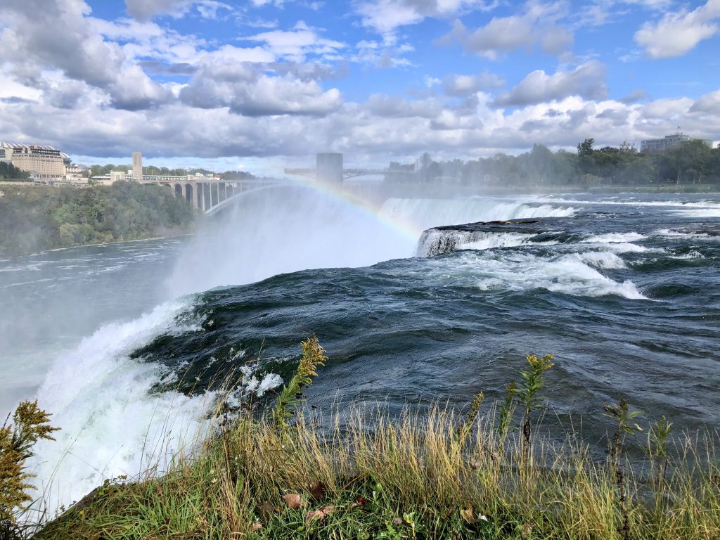 Rainbow above the cascading America Falls. At Goat Island