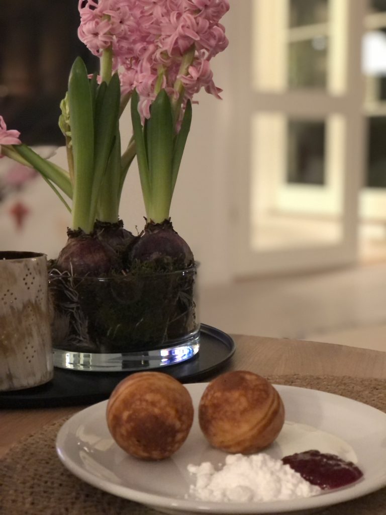 Danish pancake puffs (æbleskiver) with powdered sugar is a reason to visit Copenhagen in the wintertime