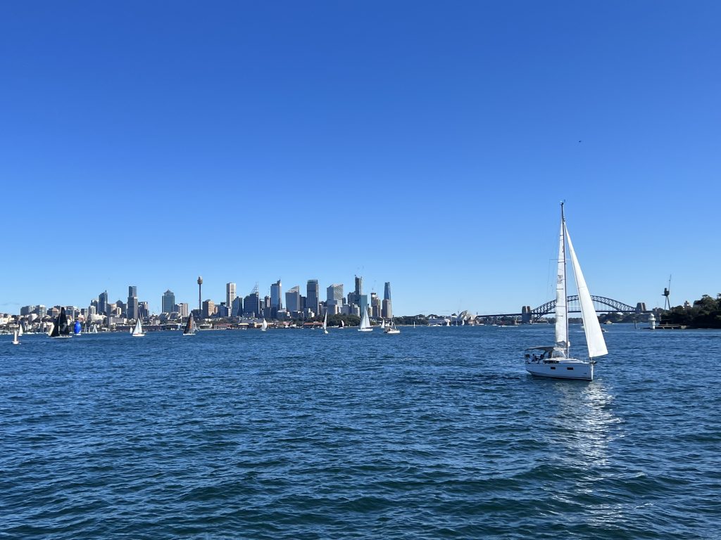 View of Sydney Harbor from the ferry to Manley, the skyline, Harbor Bridge, and sailboats