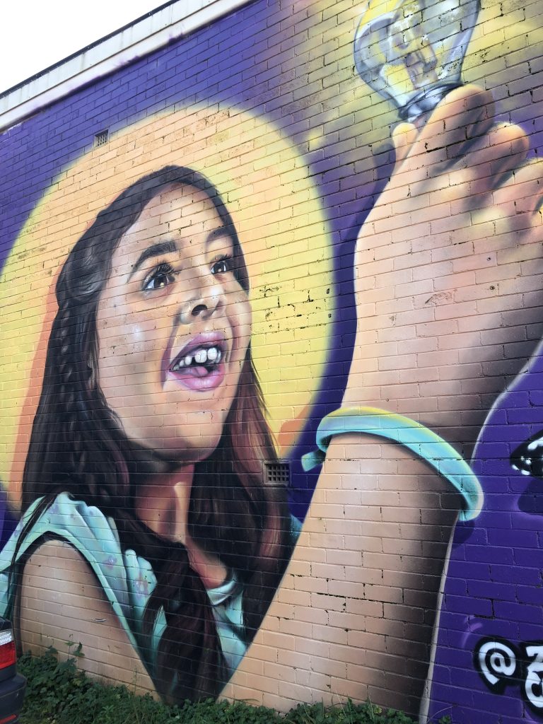 Mural from Katoomba in Australia of happy girl with a light bulb - giving a symbolic meaning to the piece My Kids Grew up - Now it's My Turn