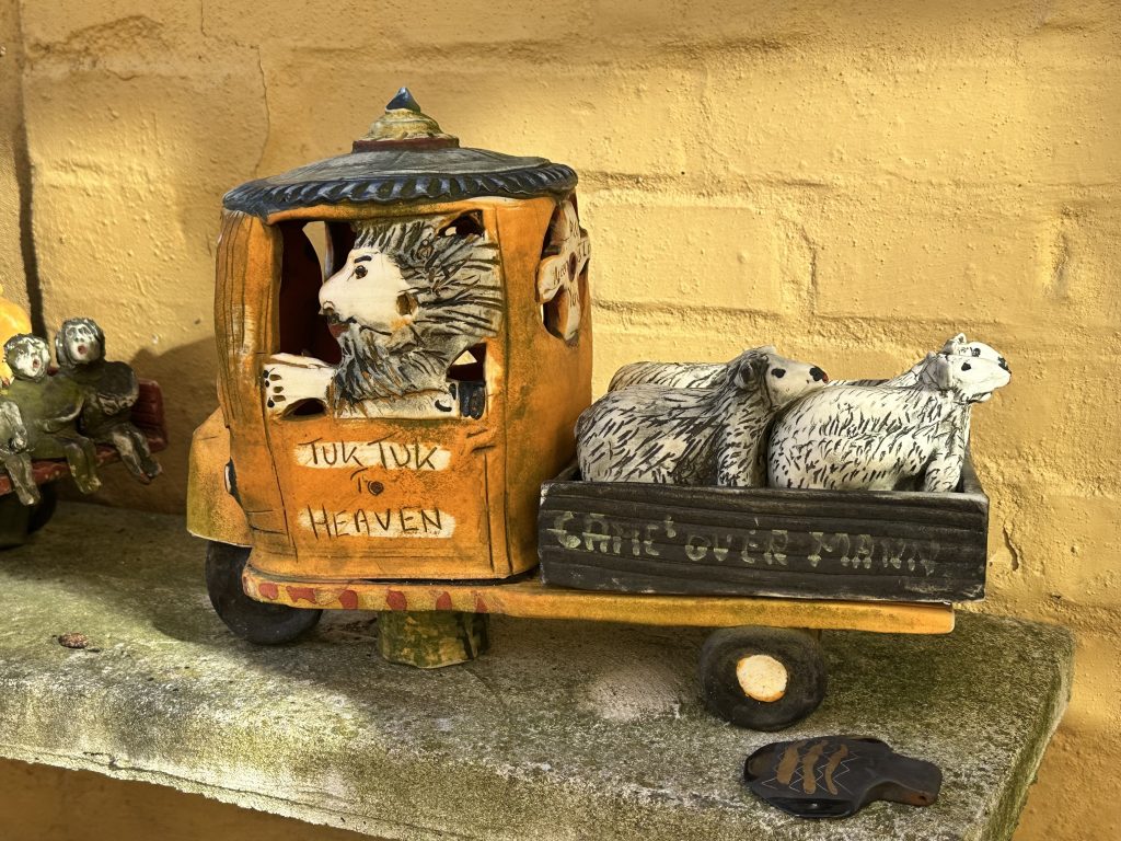 Sculpture of a tuk tuk with a man and sheep from Lange Kunsthåndværk in Ålborg, Denmark -to highlight the theme: midlife in motion