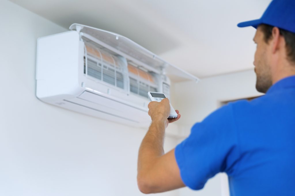 air conditioning - worker install conditioner in the room