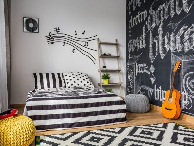 Monochrome bedroom interior for young guitar musician