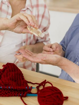 elder-women-home-sanitizing-their-hands