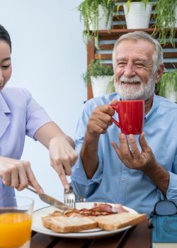 nurse-assist-elderly-senior-man-eat-breakfast-drink-coffee-with-mug-hand-nursing-home_554837-199