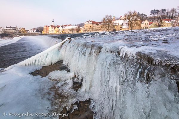 Das vereiste Lechwehr und die Altstadt von Landsberg im Winter