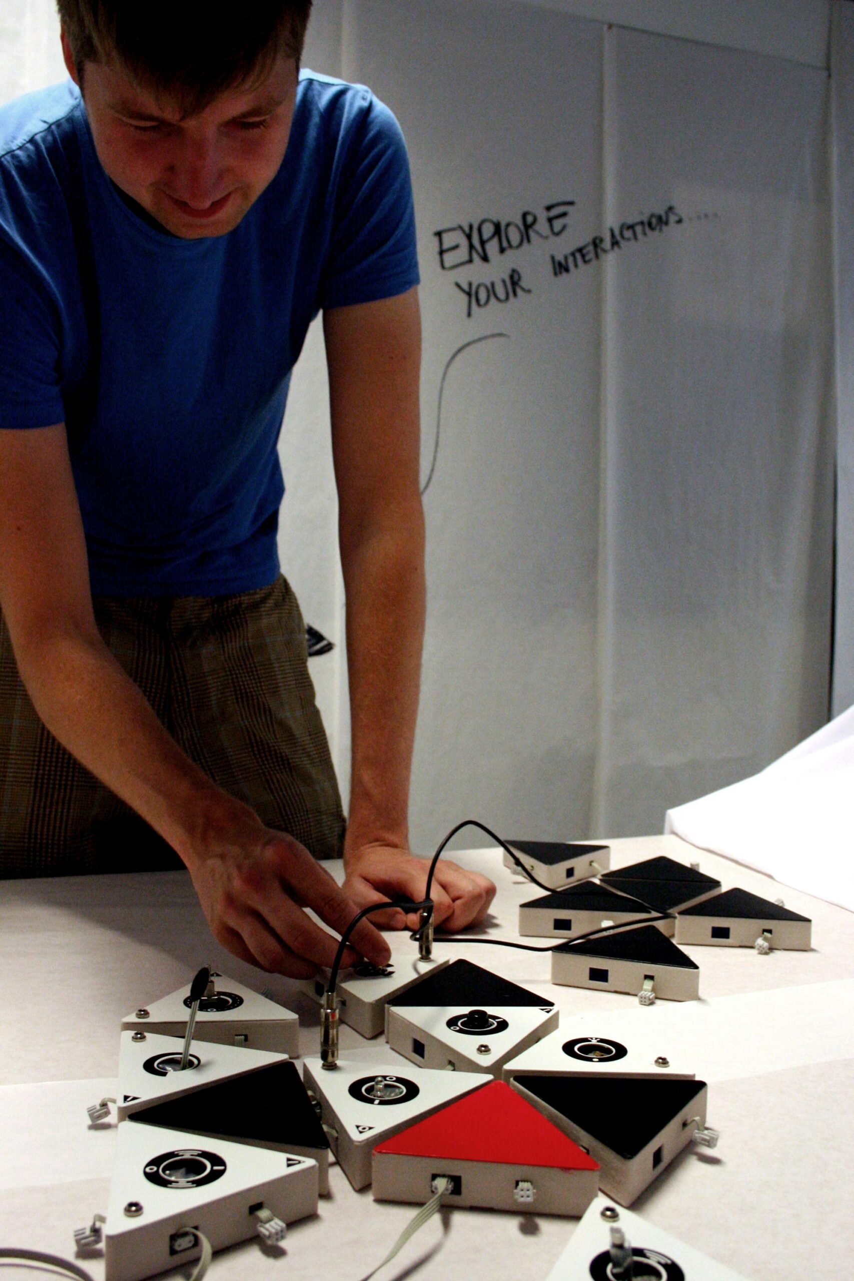 A person using Atreyu on a table. The background says: explore your interactions